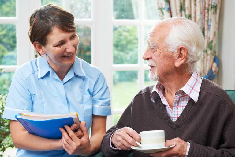 An older couple sitting together in a bright, comfortable apartment, sharing tea and reading.